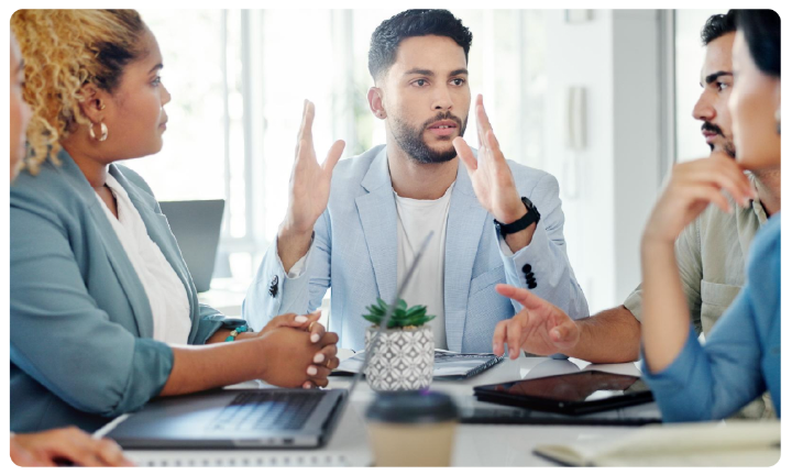 A group of people sitting at a table
AI-generated content may be incorrect.